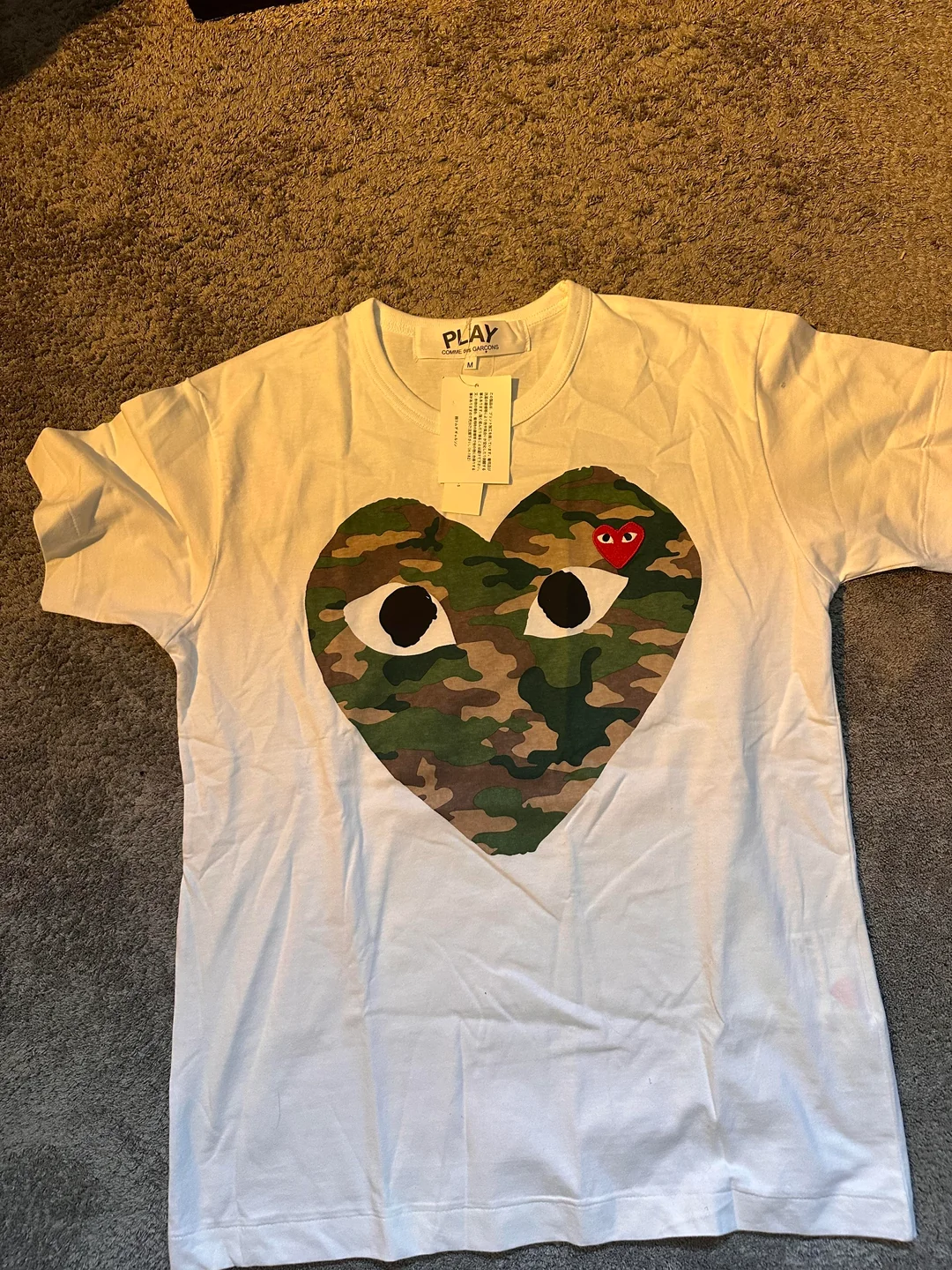 LitBuy QC photo — Comme des Garçons PLAY heart logo tee print close-up from spreadsheet summer haul